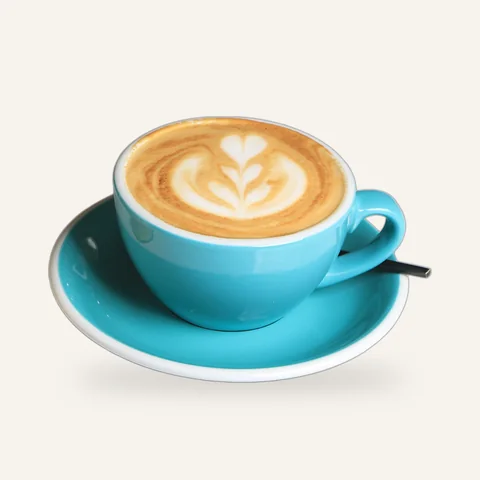 Cappuccino with latte art in a teal cup