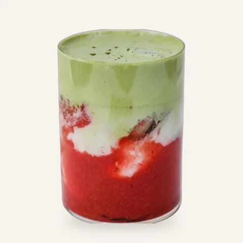 Iced strawberry matcha latte in a tall glass
