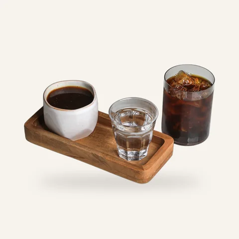 Filter coffee on a wooden tray with a glass of water