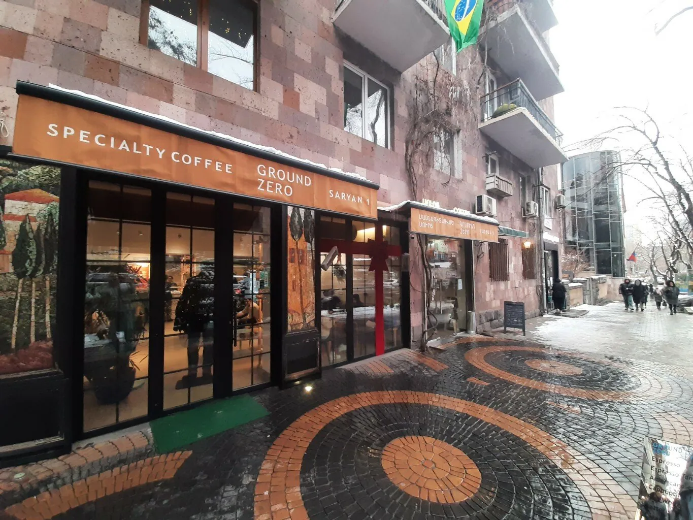 Ground Zero on Saryan Street: orange awning over the windows and the mosaic pavement